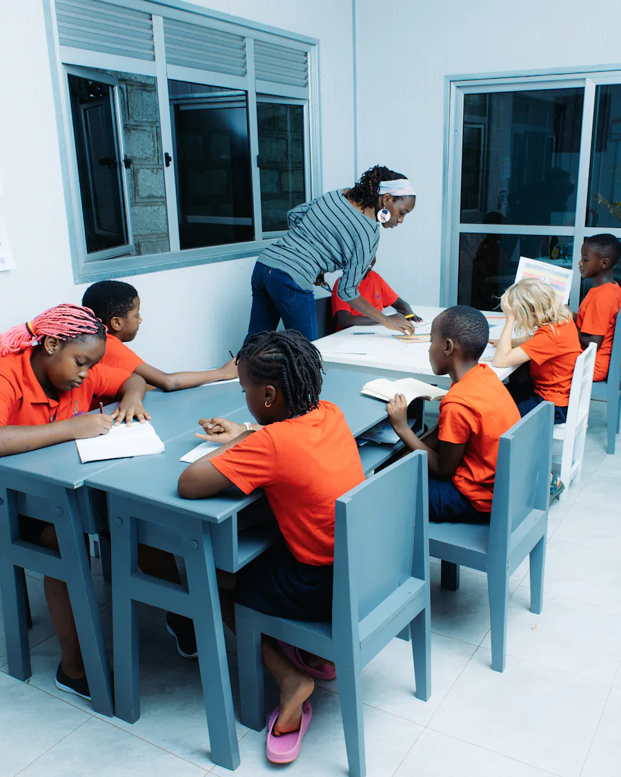 Educadora voluntária auxiliando alunos em sala de aula de projeto social